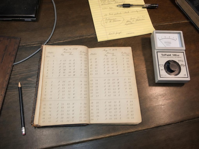 Foote field journal open on researcher kitchen table alongside TriField EMF meter and handwritten notes, 2002